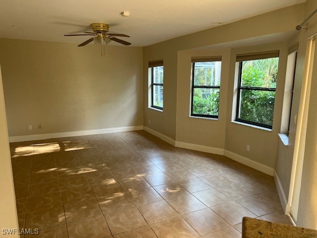 spare room featuring tile patterned flooring and ceiling fan