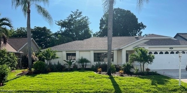 single story home with a front yard and a garage