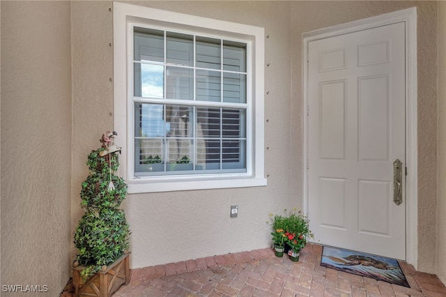 doorway to property with stucco siding