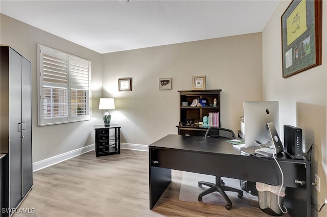 home office featuring baseboards and light wood-style floors