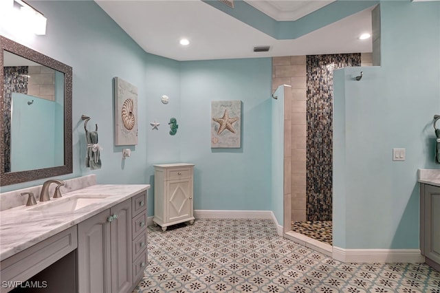 full bathroom featuring recessed lighting, vanity, visible vents, baseboards, and walk in shower