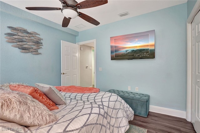 bedroom with dark wood-style flooring, visible vents, ceiling fan, and baseboards