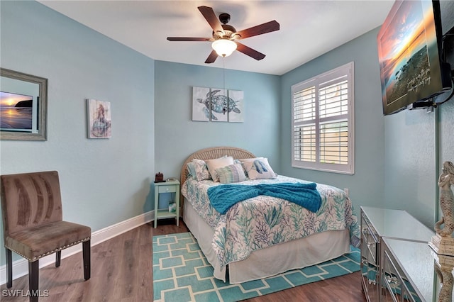 bedroom featuring a ceiling fan, dark wood-style flooring, and baseboards