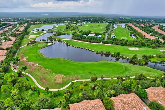 birds eye view of property with a water view and golf course view