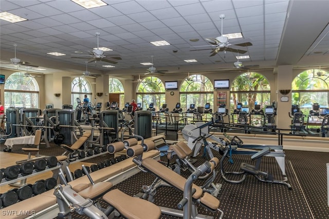 workout area featuring a drop ceiling and a ceiling fan