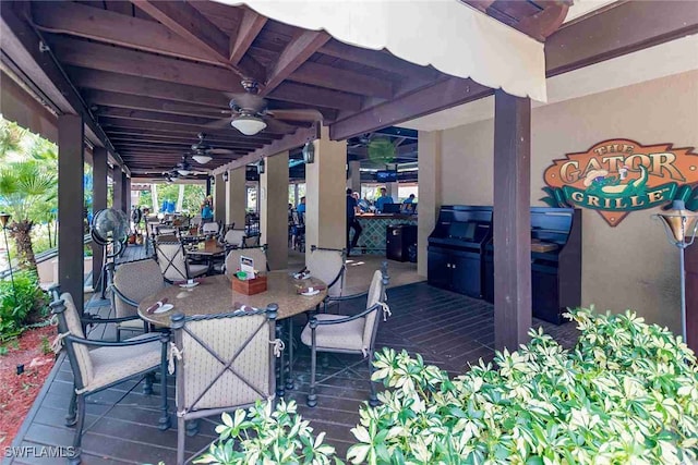 view of patio / terrace featuring an outdoor bar and a ceiling fan