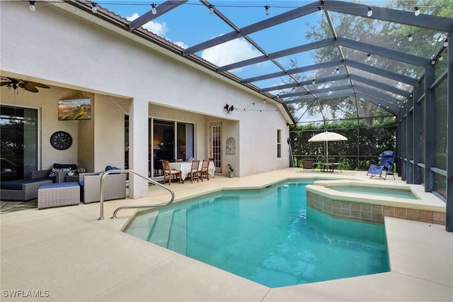 view of swimming pool featuring an in ground hot tub, a patio area, glass enclosure, ceiling fan, and an outdoor hangout area