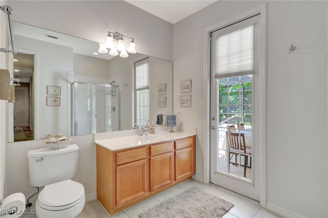 bathroom featuring tile patterned flooring, toilet, a notable chandelier, a shower with shower door, and vanity