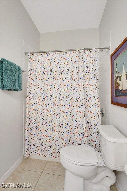 bathroom with toilet, a shower with shower curtain, and tile patterned flooring