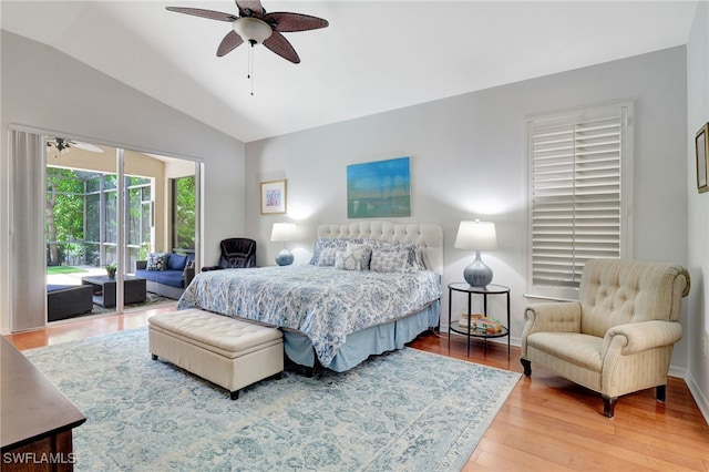 bedroom with ceiling fan, hardwood / wood-style flooring, access to outside, and vaulted ceiling