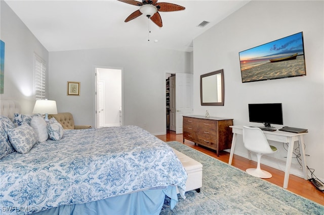 bedroom with lofted ceiling, ceiling fan, and light hardwood / wood-style floors