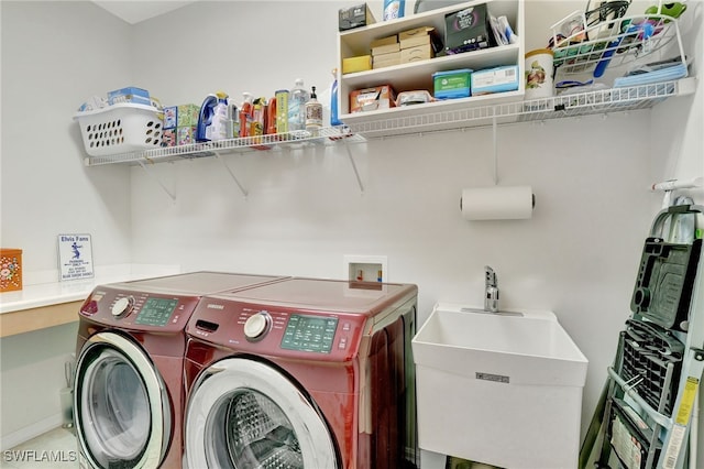 laundry room featuring washing machine and dryer and sink