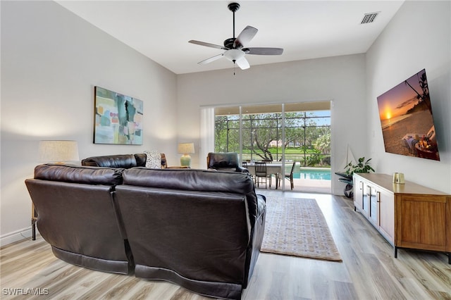 living room featuring light hardwood / wood-style flooring and ceiling fan