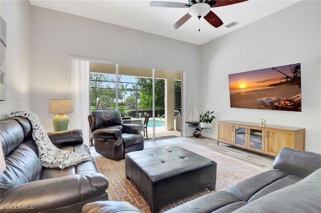 living room featuring ceiling fan and light hardwood / wood-style flooring