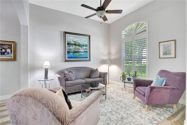 living room featuring ceiling fan, vaulted ceiling, and light hardwood / wood-style flooring