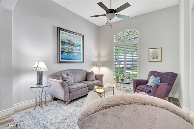 living room featuring ceiling fan and hardwood / wood-style flooring