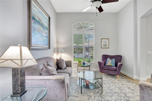 living room with ceiling fan and light wood-type flooring