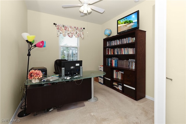 carpeted office space with ceiling fan