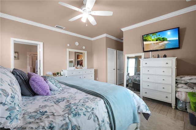 bedroom with light hardwood / wood-style flooring, ceiling fan, connected bathroom, and crown molding