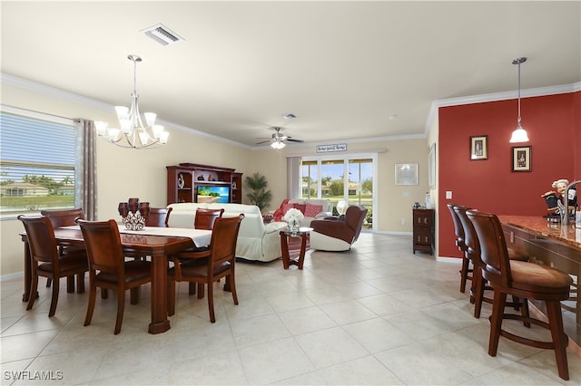 dining area with ornamental molding, ceiling fan with notable chandelier, and light tile patterned floors