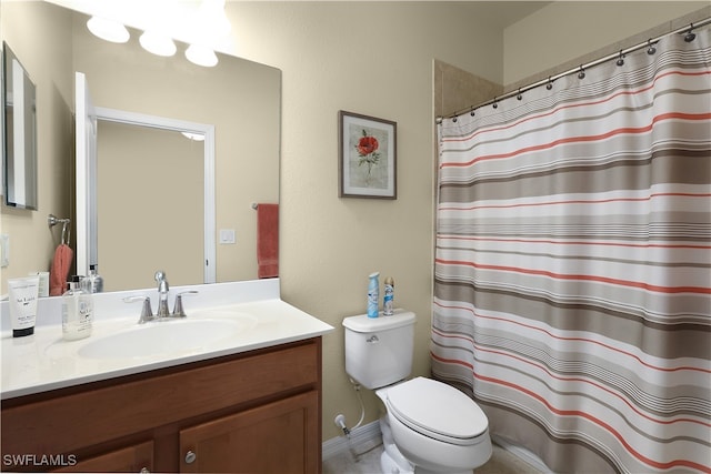 bathroom featuring toilet, vanity, and curtained shower