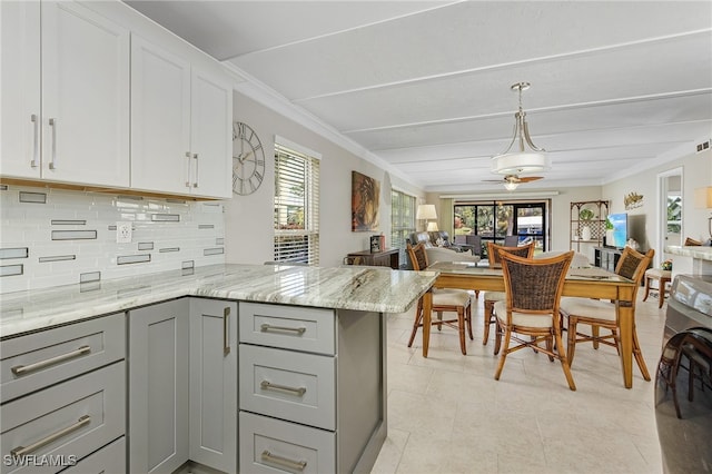 kitchen featuring a peninsula, gray cabinets, washer / dryer, and white cabinets