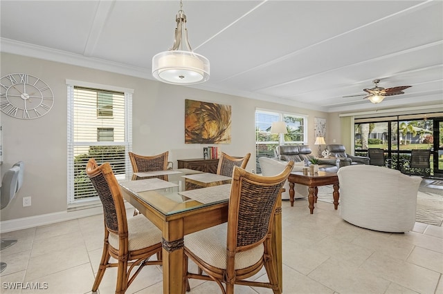 dining space with light tile patterned floors, baseboards, ornamental molding, and ceiling fan