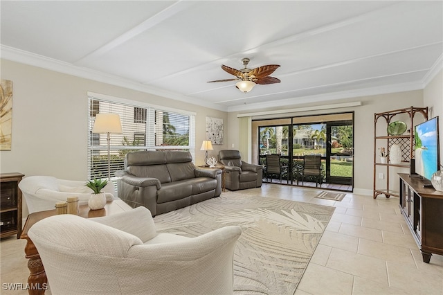 living area featuring plenty of natural light, ornamental molding, ceiling fan, and light tile patterned flooring