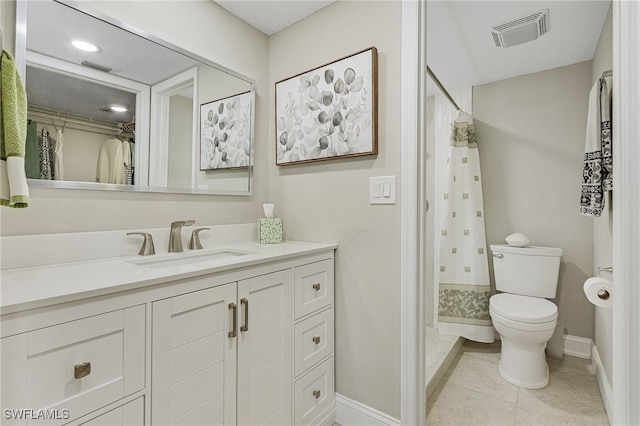 bathroom with tile patterned floors, vanity, and toilet