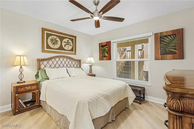 bedroom with a ceiling fan, light wood-style flooring, and baseboards