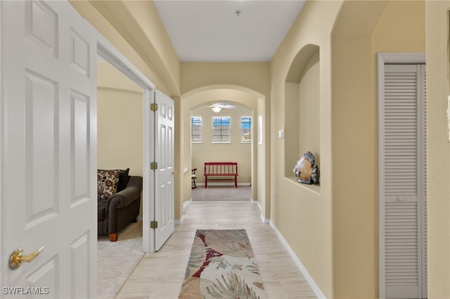 hallway featuring light colored carpet