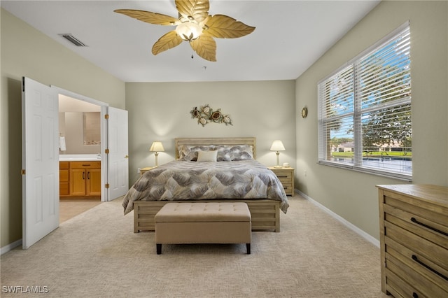 carpeted bedroom featuring ceiling fan and connected bathroom