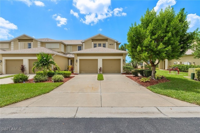 view of front of house with a garage and a front yard