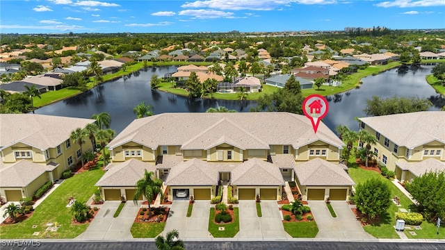 birds eye view of property with a water view