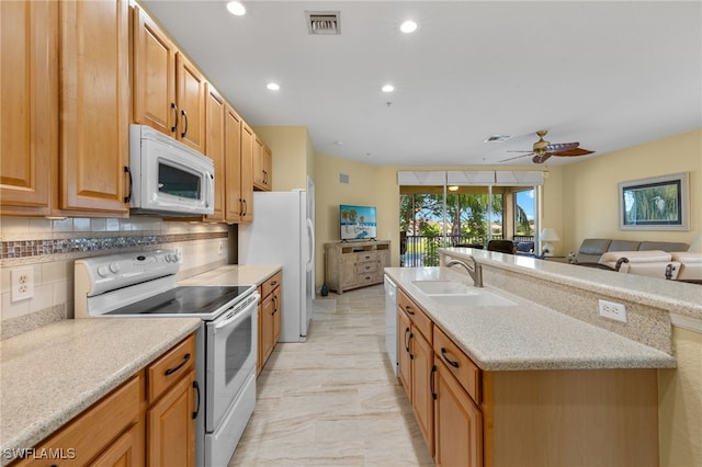 kitchen featuring backsplash, sink, light tile patterned floors, white appliances, and ceiling fan