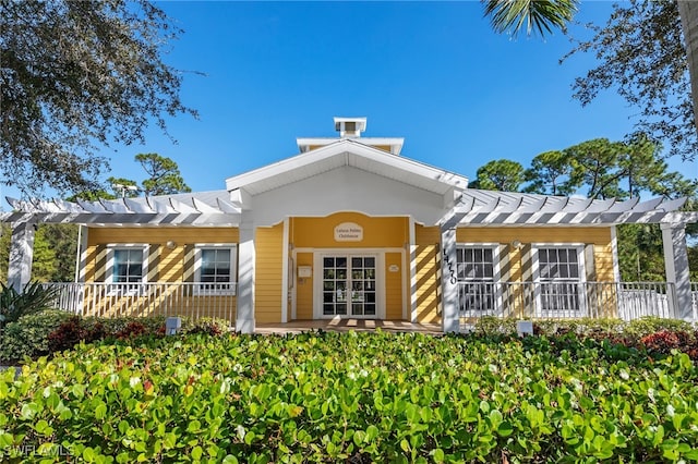 back of property featuring a pergola