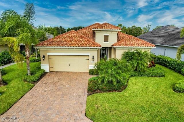 mediterranean / spanish-style home featuring a garage and a front lawn