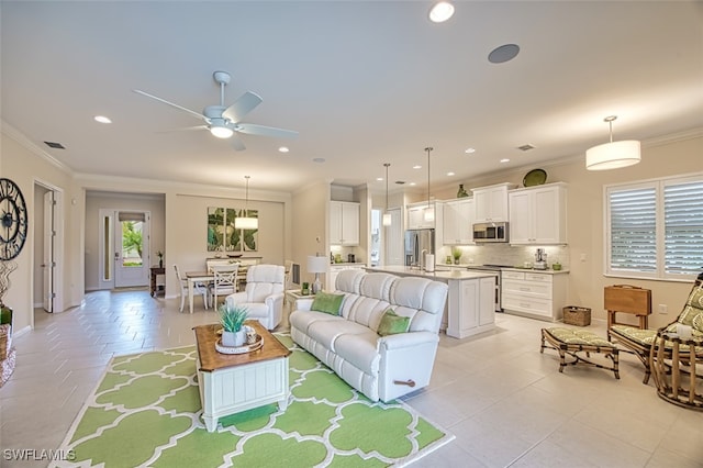 living room featuring ceiling fan, light tile patterned flooring, and ornamental molding