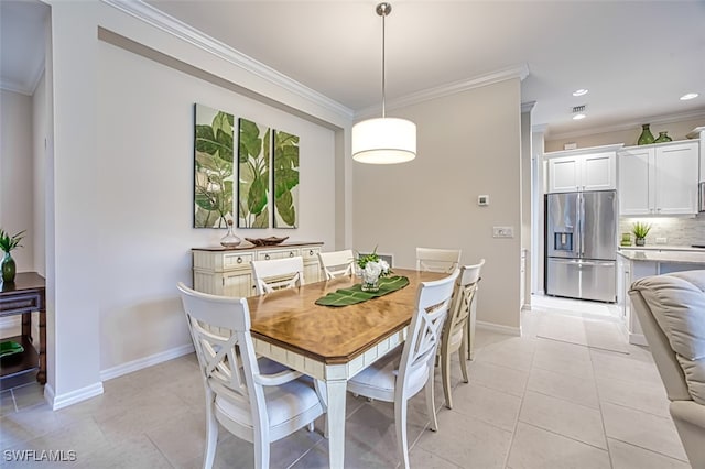 dining space featuring light tile patterned flooring and ornamental molding