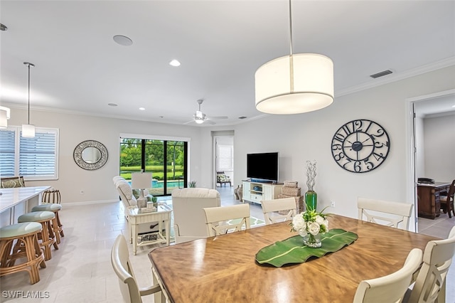 dining space with ceiling fan, light tile patterned floors, and crown molding