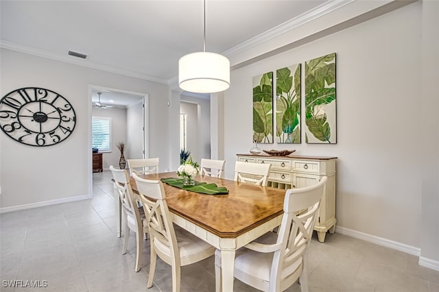 dining area with ceiling fan, light tile patterned flooring, and ornamental molding