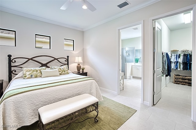 bedroom featuring ornamental molding, ceiling fan, light tile patterned floors, connected bathroom, and a closet