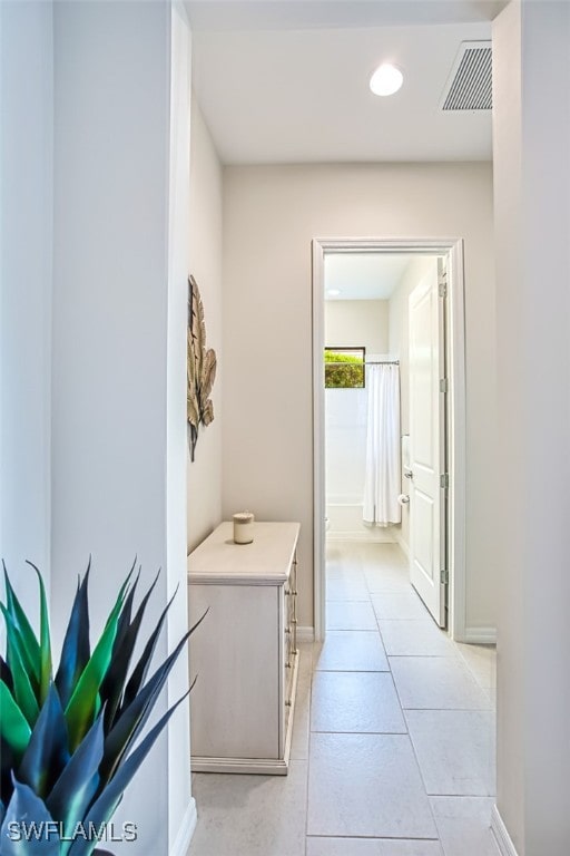 hall with light tile patterned floors