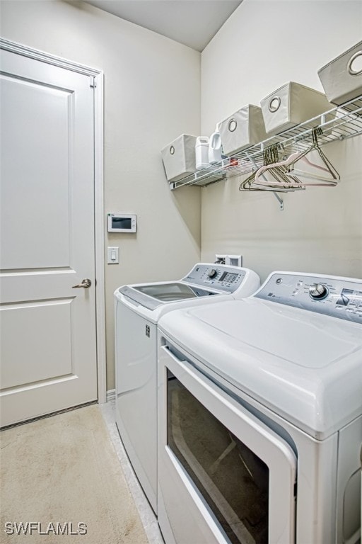 laundry area featuring washing machine and clothes dryer