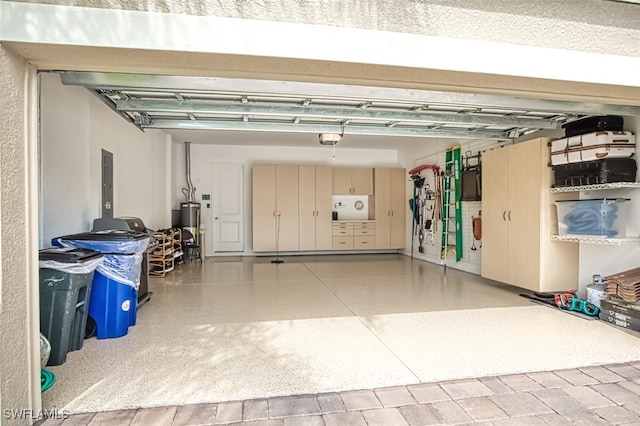 garage with water heater and a garage door opener