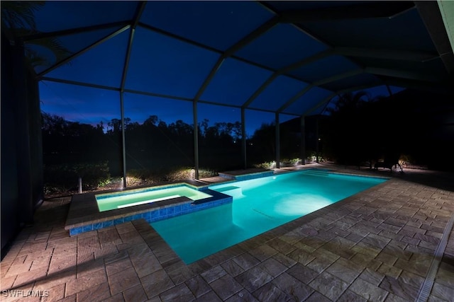 view of pool featuring a lanai, an in ground hot tub, and a patio