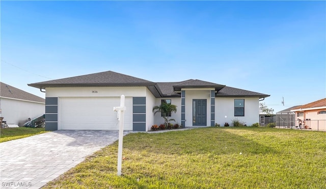 view of front of home featuring a front lawn and a garage