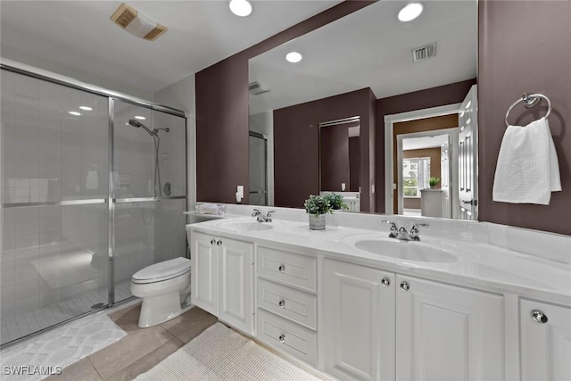 bathroom with vanity, an enclosed shower, toilet, and tile patterned floors