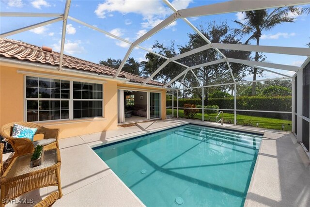 view of swimming pool with a lanai and a patio area