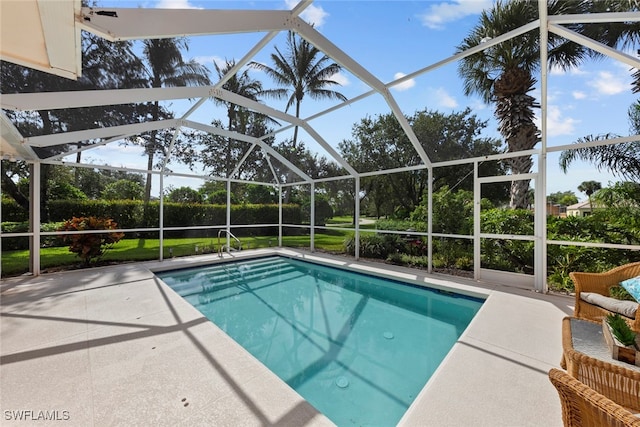 view of swimming pool featuring glass enclosure and a patio